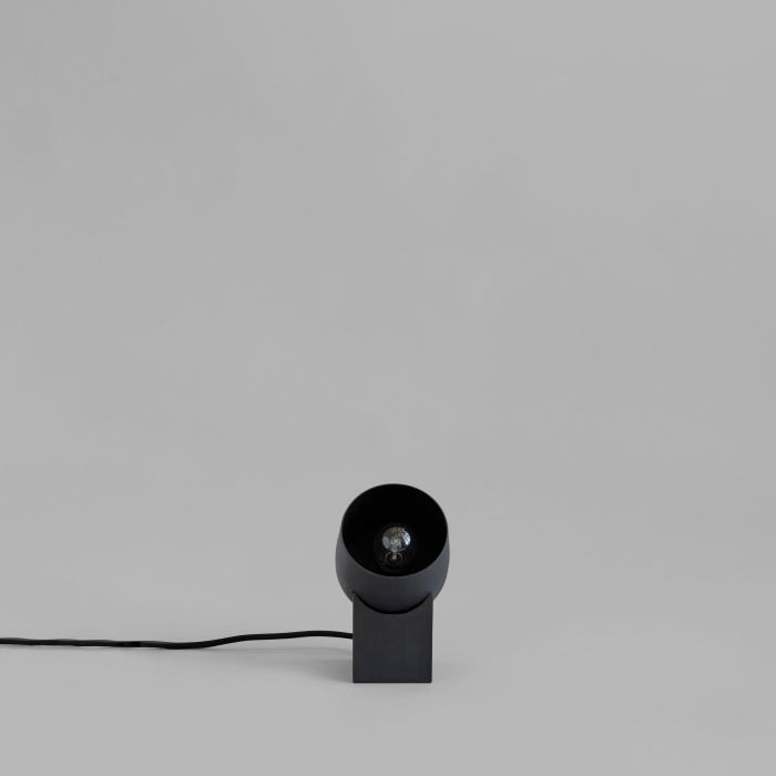 Pivot Table Lamp by 101 Copenhagen with its geometric, rotating design placed on a modern console table.