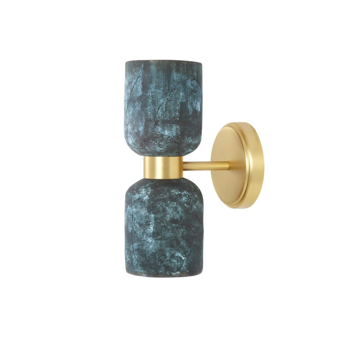 Wall sconce with blue marbled design and gold finish on a white background