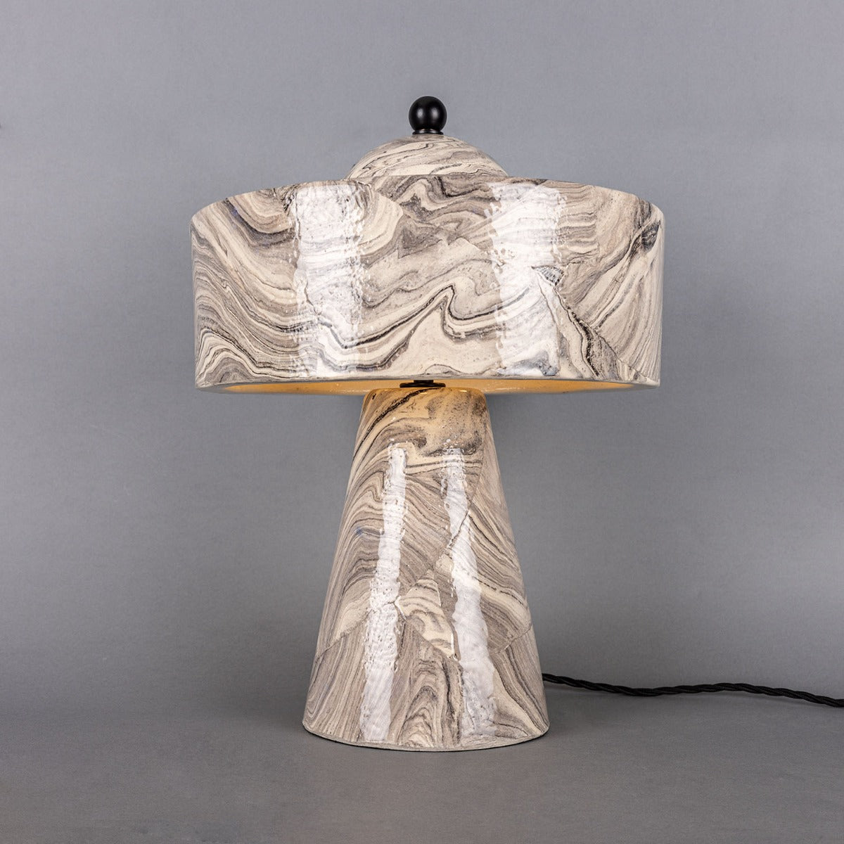 Marble-patterned table lamp on a gray background