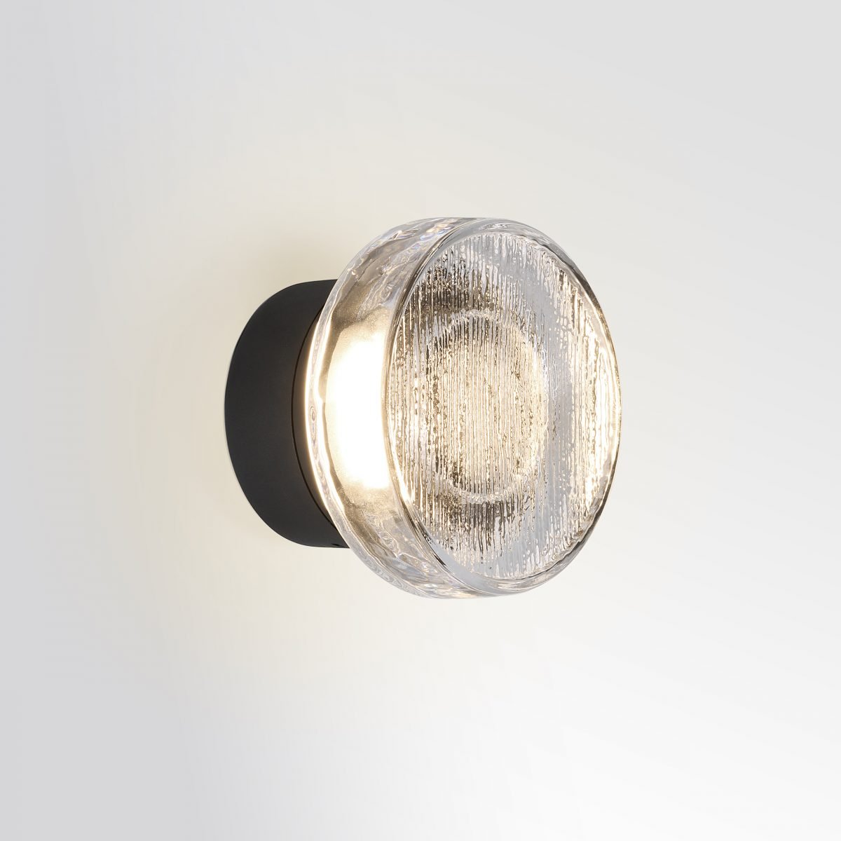 Roc wall lamp by Marset with soft diffused light, sculpted ceramic design and warm ambient glow, ideal for modern interiors and decorative wall lighting