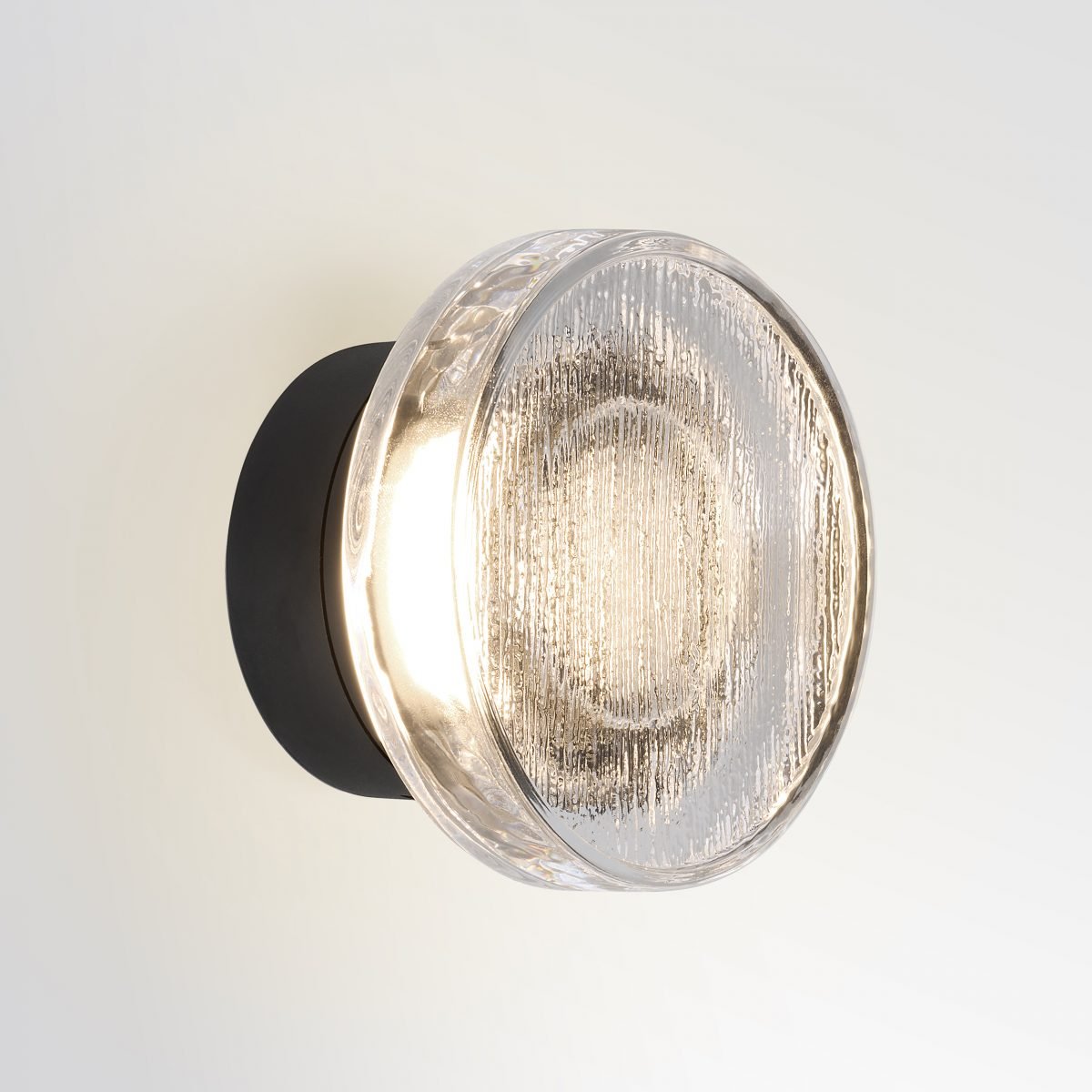 Roc wall lamp by Marset with soft diffused light, sculpted ceramic design and warm ambient glow, ideal for modern interiors and decorative wall lighting