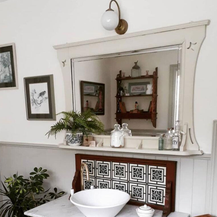 Bragan Glass Globe Wall Lamp by Mullan Lighting with a sleek brass fixture and rounded glass globe, ideal for stylish and ambient interior lighting