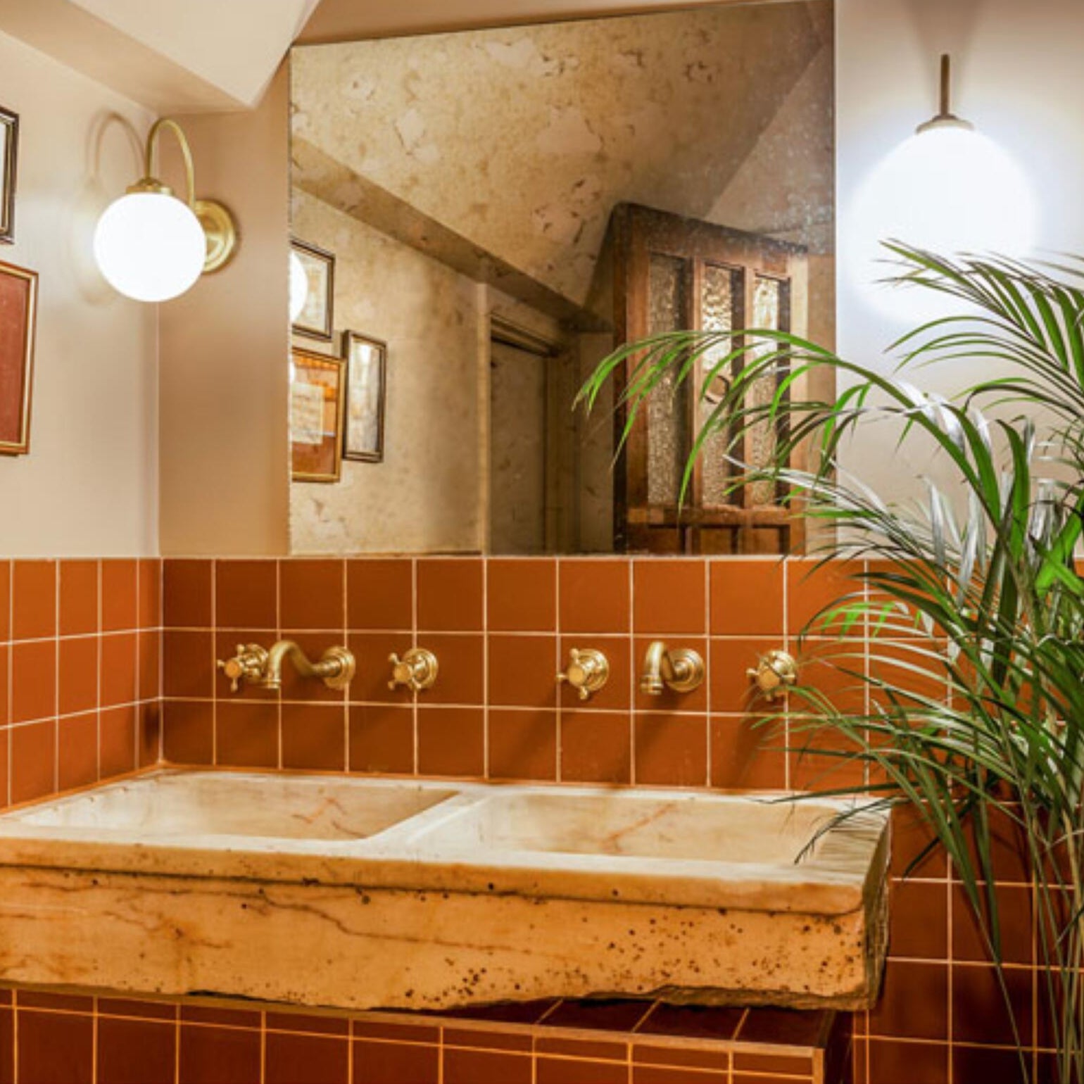 Bragan Glass Globe Wall Lamp by Mullan Lighting with a sleek brass fixture and rounded glass globe, ideal for stylish and ambient interior lighting