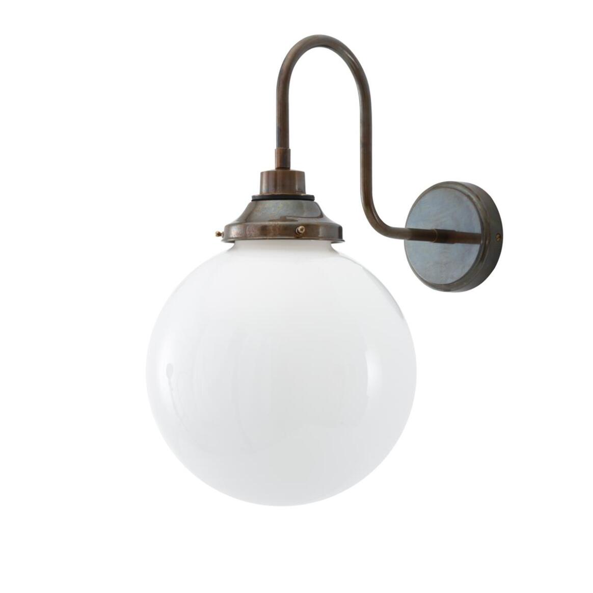 Wall-mounted light fixture with a white globe and bronze arm on a white background