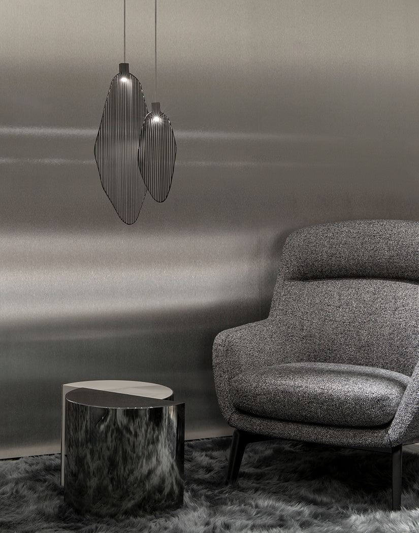 Artistic harp-inspired pendant light from Terzani featuring elegant curved metal elements.