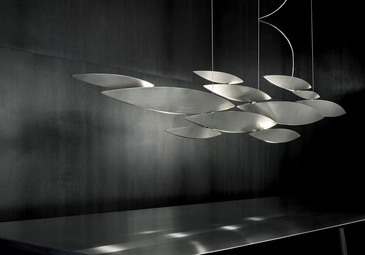 Luxury Italian pendant light—Terzani I Lucci Argentati featuring shimmering linear forms