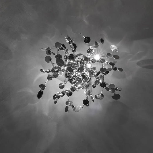Luxury Italian wall light—Terzani Argent featuring reflective sculptural metal elements
