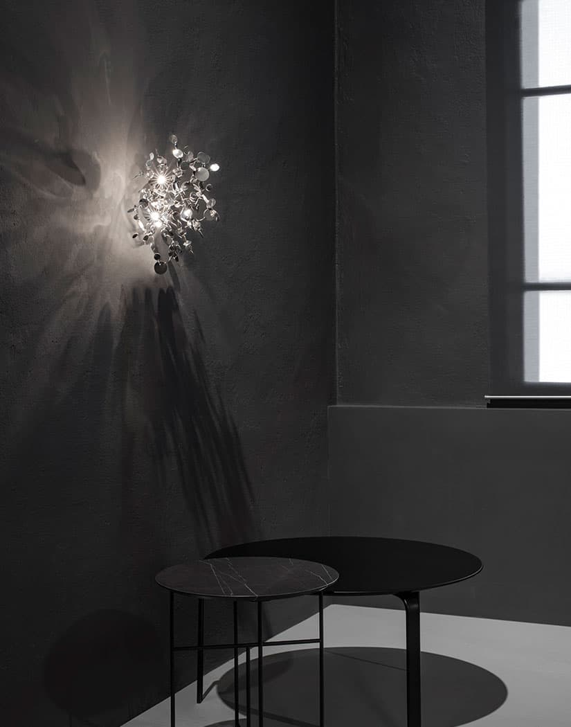 Luxury Italian wall light—Terzani Argent featuring reflective sculptural metal elements