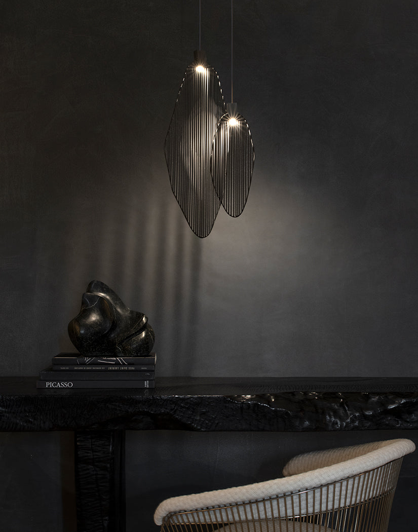 Artistic harp-inspired pendant light from Terzani featuring elegant curved metal elements.
