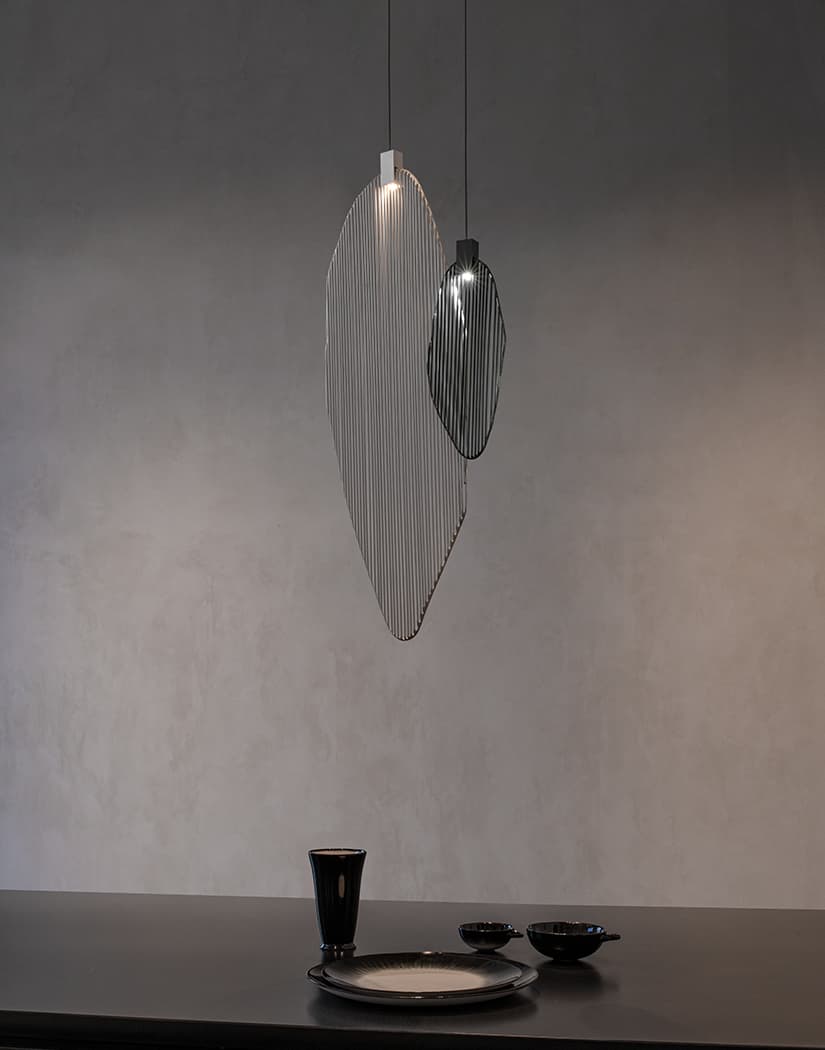 Artistic harp-inspired pendant light from Terzani featuring elegant curved metal elements.