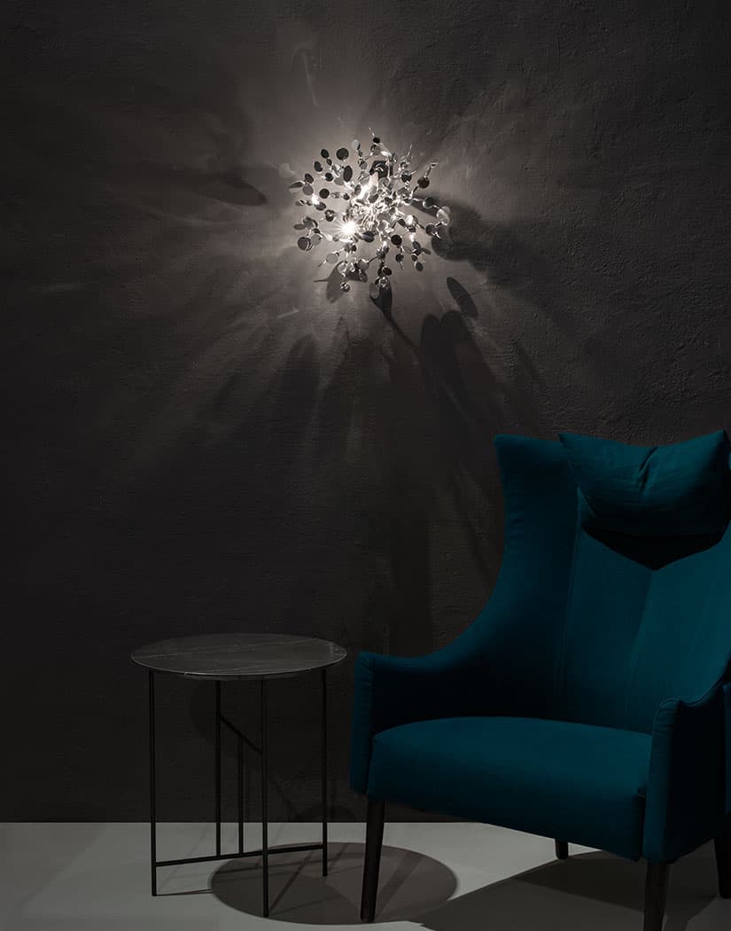 Luxury Italian wall light—Terzani Argent featuring reflective sculptural metal elements